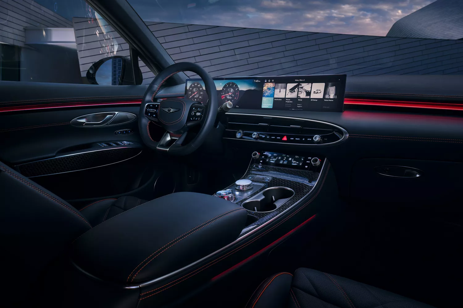 The interior of a car at dusk, showing the steering wheel, dashboard, infotainment screen, and center console.