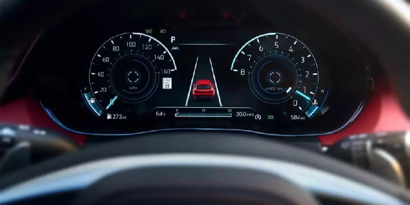 Digital car dashboard showing speed, RPM, various indicators, and a red car icon in a lane on a dark background.
